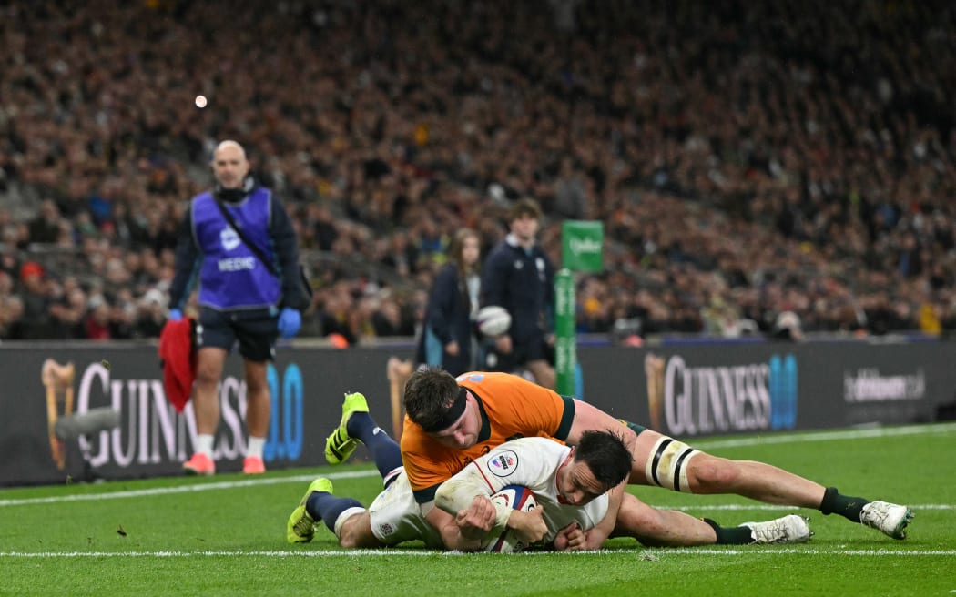 England's scrum-half Alex Mitchell scores the team's third try during the Autumn Nations Series international rugby union match between England and Australia at Allianz Stadium, Twickenham, in south-west London, on November 1, 2025. (Photo by Glyn KIRK / AFP)