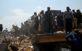 Emergency personnel at the site of a school building which collapsed in Lagos on March 13, 2019.