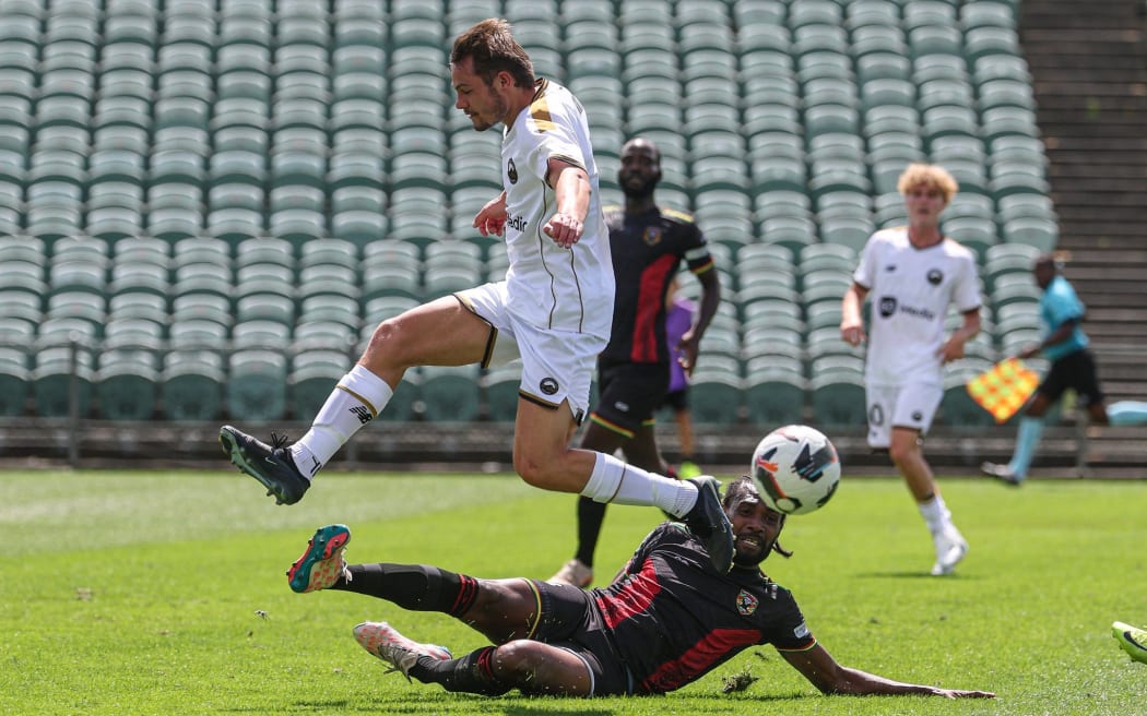 Vanuatu United FC’s Jason Thomas slides to tackle against South Island United’s Ryan Feutz during their OFC Pro League 2026, clash at the North Harbour Stadium Auckland, Friday 23 January 2026. Photo: Shane Wenzlick / www.phototek.nz
