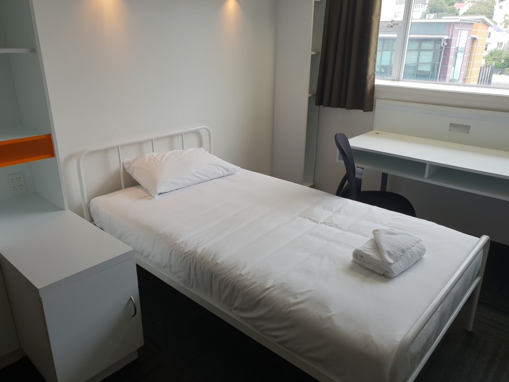 The wide-open plan rooms contain a simple kitchen and bathroom, a couple of beds.