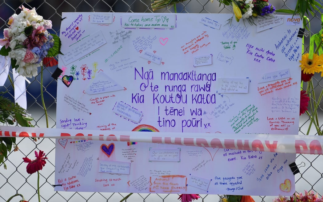 A card is pinned to a fence on the waterfront signed by locals with messages to those lost and injured by the White Island eruption on December the 9, in Whakatane, in Bay of Plenty on December 12, 2019.