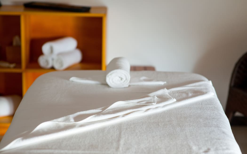 rolled towel on massage table in spa center