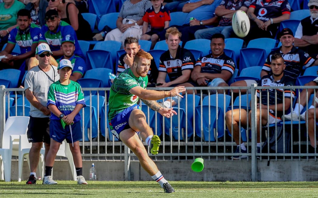 Adam Keighran of the Warriors takes a kick for a goal.