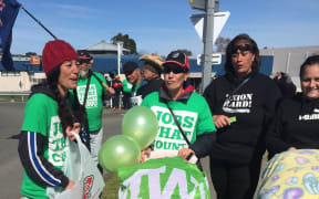 People wave balloons and banners at a protest at the Wairoa Bridge in Hawke's Bay over AFFCO employment contracts.