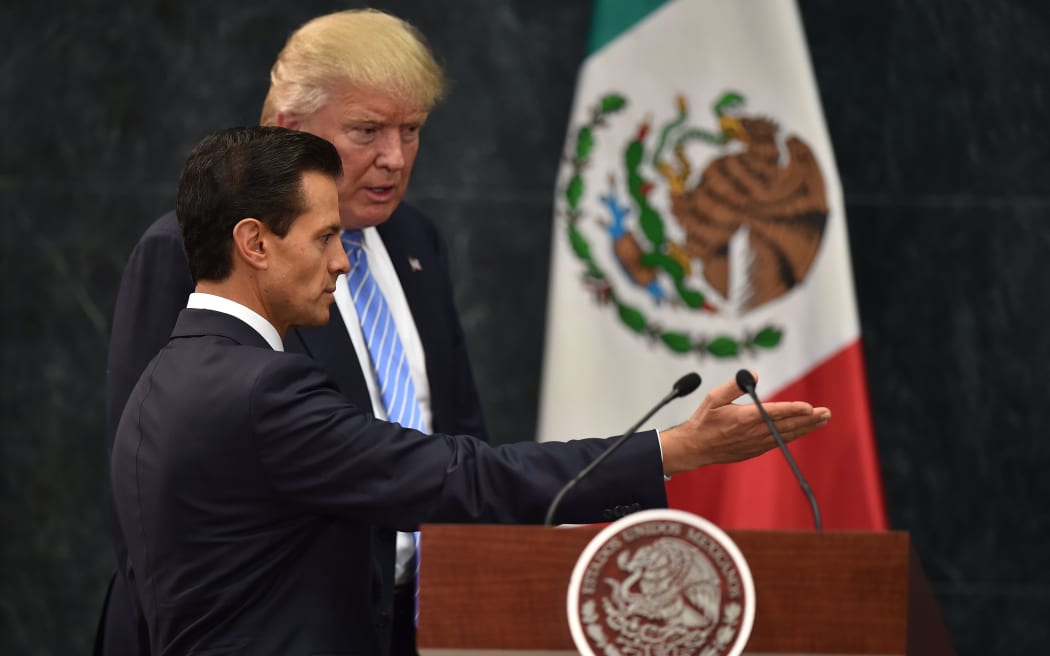 Mexican President Enrique Pena Nieto and US Republican presidential hopeful Donald Trump speak to press after an hour of meetings ahead of Mr Trump's speech on immigration in Arizona.