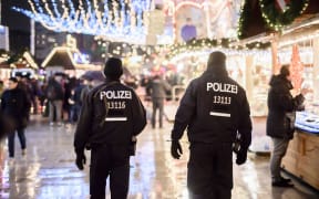 Police patrols at the reopened Christmas market near the Kaiser Wilhelm Memorial Church in Berlin.