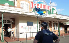 A police officer stands in front of the Dreamworld theme park on Gold Coast on 25 October, 2016, after four people were killed when a park ride malfunctioned.