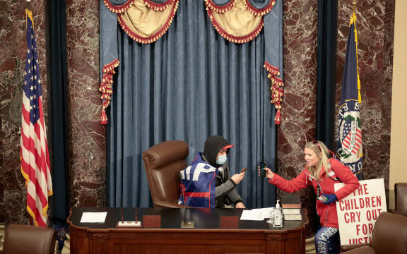 A protester sits in the Senate Chamber on January 06, 2021 in Washington, DC.