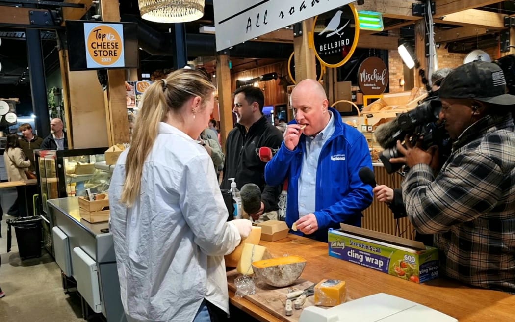 National Party leader Christopher Luxon samples food from a stall during a walkabout at Riverside Market in central Christchurch on 14 September, 2023.