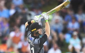 Martin Guptill hits a six during the third T20.