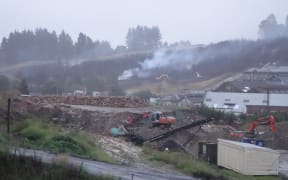 The fire is dampened down the morning after the fire.