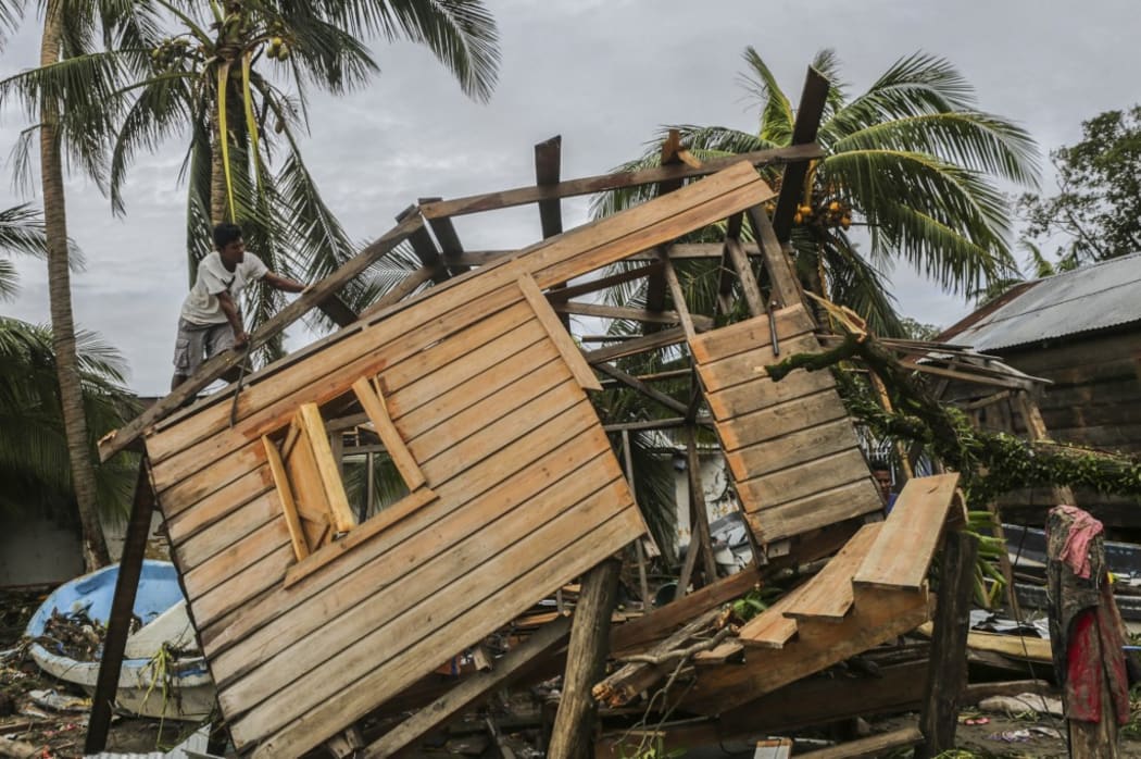 Men fix a small house in "El Muelle" Neighbourhood in Bilwi, Nicaragua on November 5, 2020, after the passage of hurricane Eta.