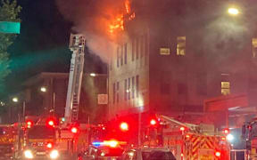 Flames seen in the top storey of the Loafers Lodge accommodation in Adelaide Road, Newtown, Wellington.