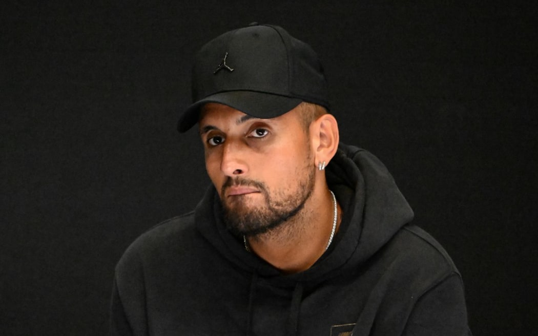 Australia's Nick Kyrgios speaks during a press conference on day one of the Australian Open tennis tournament in Melbourne on January 16, 2023. - Kyrgios pulled out of the Australian Open on January 16 without hitting a ball because of a knee injury, saying he was "devastated". (Photo by Saeed KHAN / AFP) / -- IMAGE RESTRICTED TO EDITORIAL USE - STRICTLY NO COMMERCIAL USE --