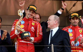 Charles Leclerc of Ferrari celebrates 2024 Monaco F1 GP win with Prince Albert II.