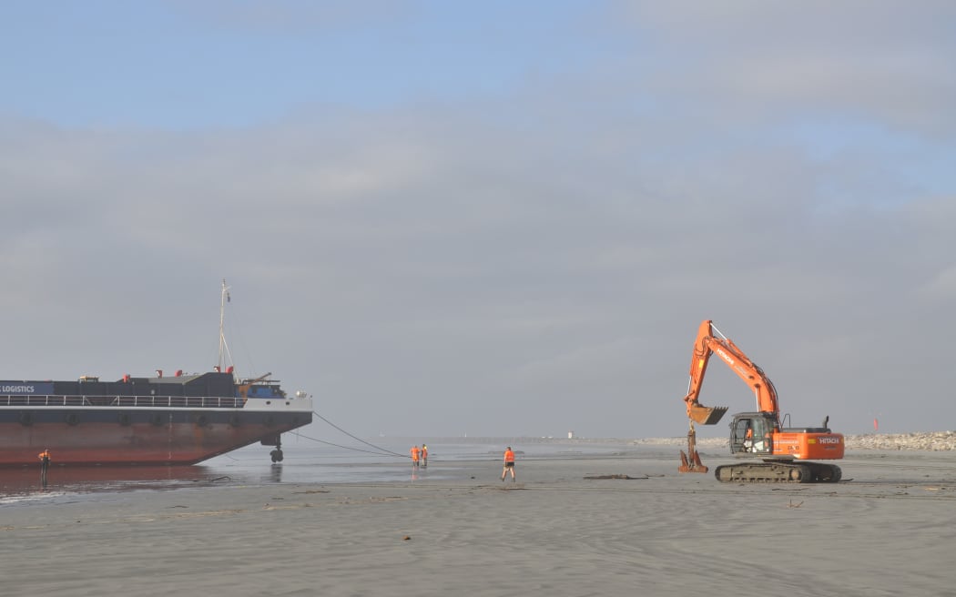 A digger working to secure the Manahau before the next high tide on Monday 2 September.