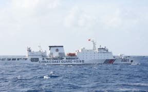 This handout photo taken on January 11, 2025 and released on January 12 by the Philippine Coast Guard (PCG) shows a Chinese Coast Guard ship sailing some 60 nautical miles (111 kilometres, 69 miles) west of the main Philippine island of Luzon while being monitored by Philipine Coast Guard ship BRP Teresa Magbanua (not pictured). The Philippines on January 12 accused China of pushing its patrol ships close to the main Filipino landmass as part of Beijing's alleged illegal grab of most of the South China Sea. (Photo by Handout / Philippine Coast Guard (PCG) / AFP) / RESTRICTED TO EDITORIAL USE - MANDATORY CREDIT "AFP PHOTO / PHILIPPINE COAST GUARD (PCG)" - NO MARKETING NO ADVERTISING CAMPAIGNS - DISTRIBUTED AS A SERVICE TO CLIENTS
