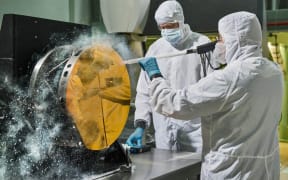 engineers are practicing "snow cleaning'" on a test telescope mirror for the James Webb Space Telescope at NASA's Goddard Space Flight Center in Greenbelt, Maryland.