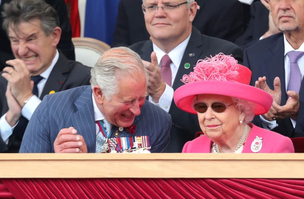 Britain's Prince Charles, Prince of Wales reacts as he sits with his mother Queen Elizabeth II during an event to commemorate the 75th anniversary of the D-Day landings, in Portsmouth, southern England, on June 5, 2019.