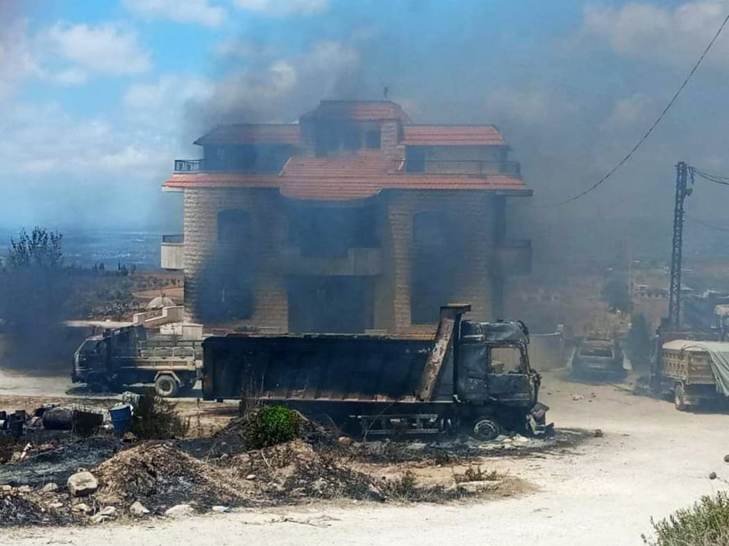 Relatives of people died when a fuel tanker exploded, set the house of owner of fuel tanker field on fire in northern Lebanon, in Akkar region on August 15, 2021. At least 28 people were killed when a fuel tanker exploded 79 others injured in the explosion.