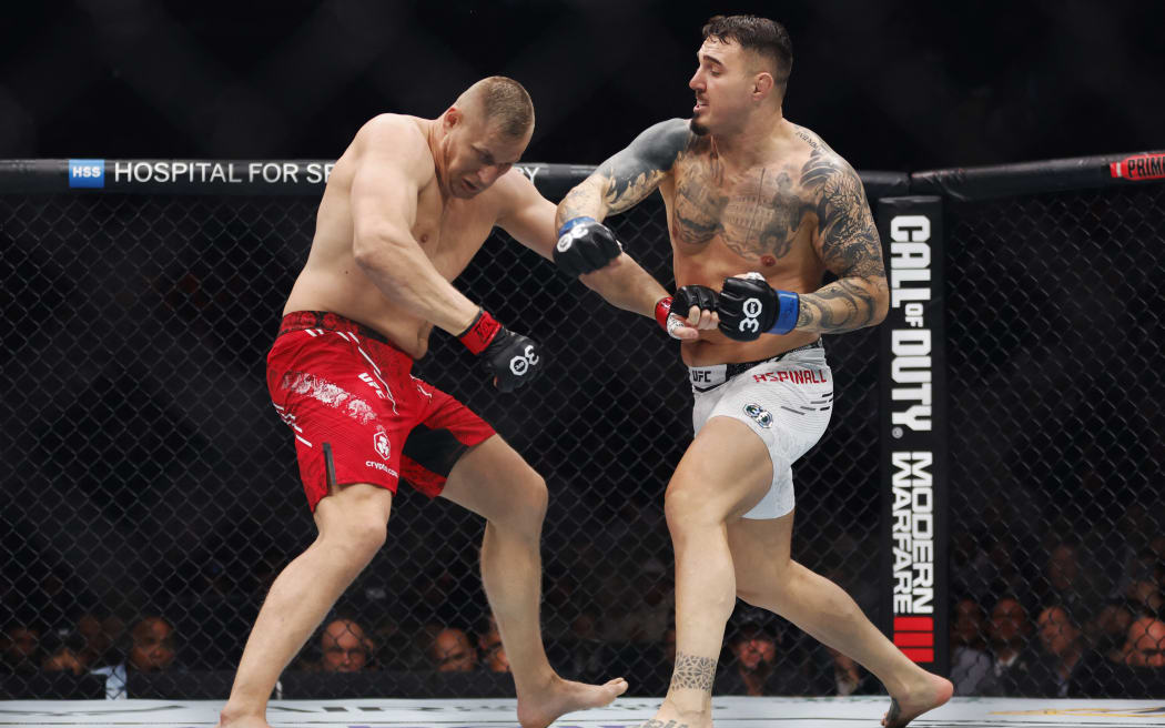NEW YORK, NEW YORK - NOVEMBER 11: (R-L) Tom Aspinall of England punches Sergei Pavlovich of Russia in the interim UFC heavyweight championship fight during the UFC 295 event at Madison Square Garden on November 11, 2023 in New York City.   Sarah Stier/Getty Images/AFP (Photo by Sarah Stier / GETTY IMAGES NORTH AMERICA / Getty Images via AFP)