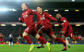 Xherdan Shaqiri of Liverpool celebrates with teammates Roberto Firmino and Georginio Wijnaldum
