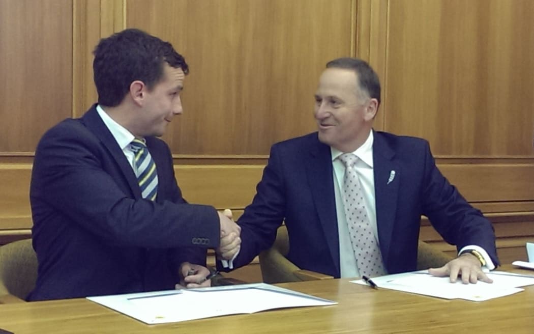 ACT MP David Seymour and Prime Minister John Key shake on their support agreement.