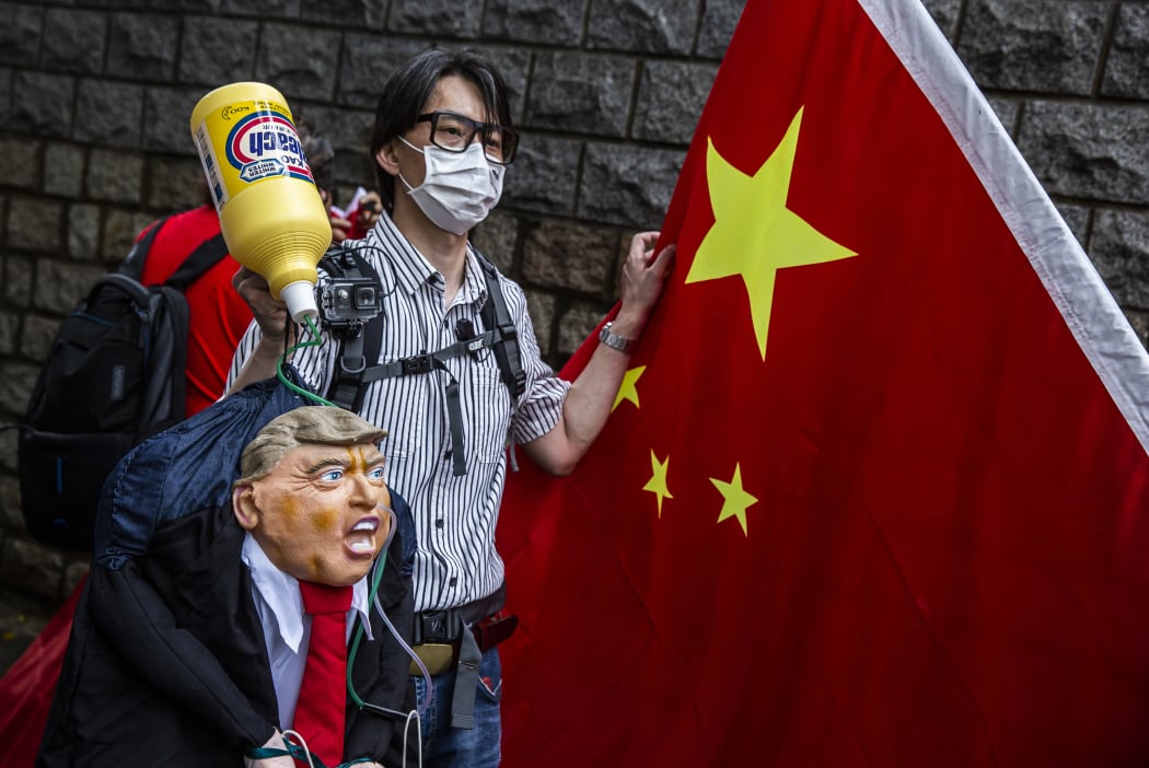 A pro-China activist holds an effigy of US President Donald Trump during a protest outside the US consulate in Hong Kong on May 30, 2020, in response to Trump's sanctions pledge.
