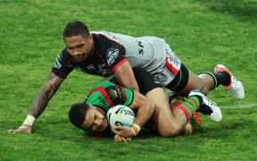 South Sydney Rabbitohs' Dylan Walker being tackled by New Zealand Warriors' wing Manu Vatuvei.