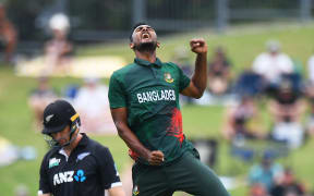Bangladesh's Shoriful Islam celebrates the wicket of Black Caps opener Will Young.