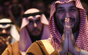 Crown Prince and Prime Minister of the Kingdom of Saudi Arabia Mohammed bin Salman and member of the Saudi Arabia reacts as US President Donald Trump speaks during the US-Saudi Investment Forum at the John F. Kennedy Center for the Performing Arts in Washington, DC on November 19, 2025. (Photo by Brendan SMIALOWSKI / AFP)