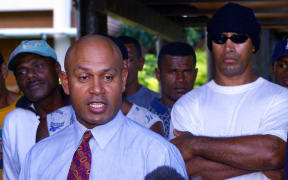 Coup leader George Speight is surrounded by bodyguards at Parliament House in Suva 03 June 2000 where former Fijian prime minister Mahendra Pal Chaudhry's government is being held hostage.  Both Speight and Fijian strongman Commodore Voreqe (Frank) Bainimarama are holding another round of talks after the military renegged on its offer to allow the Great Council of Chiefs to decide who should run the country.  (ELECTRONIC IMAGE)  AFP PHOTO/Torsten BLACKWOOD (Photo by TORSTEN BLACKWOOD / AFP)