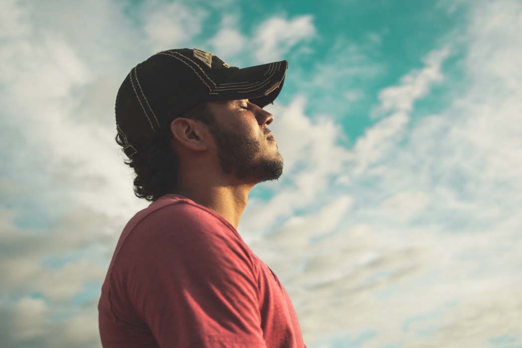 guy in cap looking at the sky