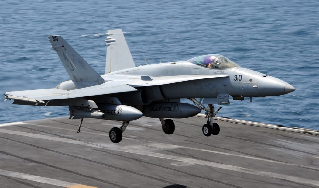 This US Navy handout photo obtained August 8, 2014 shows an F/A-18C Hornet assigned to the Valions of Strike Fighter Squadron (VFA) 15 as it prepares to land on the flight deck of the aircraft carrier USS George H.W. Bush (CVN 77)on July 29, 2014 in the Gulf.