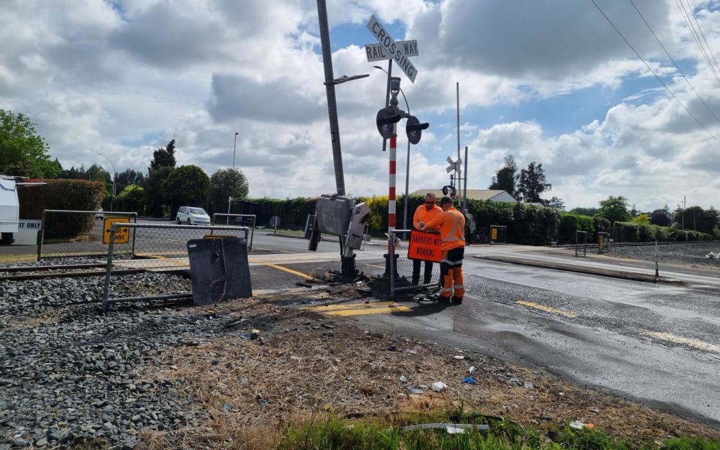Officials at the site of a car vs train crash in Hamilton on 13 November 2024.