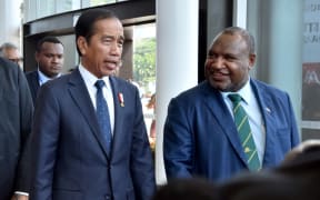 Indonesia's President Joko Widodo (L) is greeted by Papua New Guinea Prime Minister James Marape at APEC Haus ahead of bilateral meetings in Port Moresby.