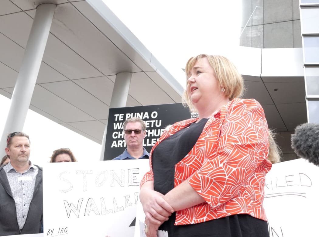 Megan Woods speaks to residents with quake damaged homes who are protesting the thousands of unresolved  earthquake insurance claims.