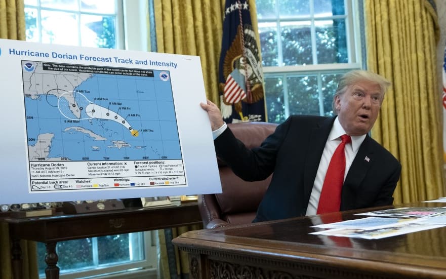 United States President Donald J. Trump holds a map that appears to show the course of Hurricane Dorian going through part of Alabama.