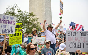 Protestors hold signs as they march towards the White House during a Free Kilmar Abrego and an Anti-Trump protest, in Washington, DC, April 19, 2025. Abrego Garcia was detained in Maryland last month and expelled to El Salvador along with 238 Venezuelans and 22 fellow Salvadorans who were deported shortly after President Donald Trump invoked a rarely-used wartime authority. 
Trump administration officials have claimed he is an illegal migrant, a gang member and involved in human trafficking, without providing evidence. 
A federal judge has since ordered he be returned, later backed up by the Supreme Court.
But the administration -- despite admitting an "administrative error" in his deportation -- contends he is now solely in Salvadoran custody. (Photo by Richard PIERRIN / AFP)