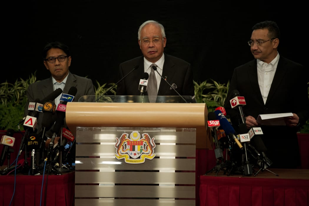 Malaysian Prime Minister Najib Razak (centre) announces the fate of Malaysia Airlines flight MH370 during a news conference in Kuala Lumpur.