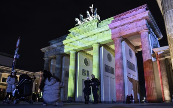 The colors of the Belgian flag are projected on to the Brandenburg Gate in Berlin as the German capital shows its solidarity following the Brussels attacks.