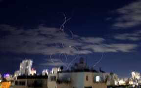 Rocket trails are seen in the sky above the Israeli center coastal city of Netanya amid a fresh barrage of Iranian missile attacks on March 9, 2026. Israel announced a new wave of "broad-scale" strikes on Tehran on March 7 as the escalating war in the Middle East entered its second week and oil prices surged on fears about global supply disruption. The US-Israeli bombing campaign unleashed on February 28 has provoked Iranian retaliation against US allies across the region, with President Donald Trump saying on March 6 that only "unconditional" Iranian surrender would end the war. (Photo by JACK GUEZ / AFP)