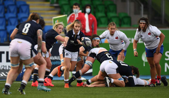 Scotland's scrum-half Mairi McDonald (C) offloads the ball during the Women's Six Nations rugby union match between Scotland and France at Scotstoun Stadium in Glasgow on October 25, 2020.