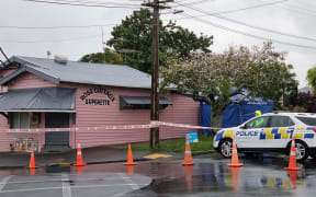 Police outside a dairy in the Auckland suburb of Sandringham where a man was fatally stabbed.