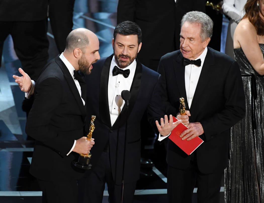 La La Land' producer Jordan Horowitz (left) announces actual Best Picture winner as 'Moonlight' after a presentation error with host Jimmy Kimmel and actor Warren Beatty onstage.