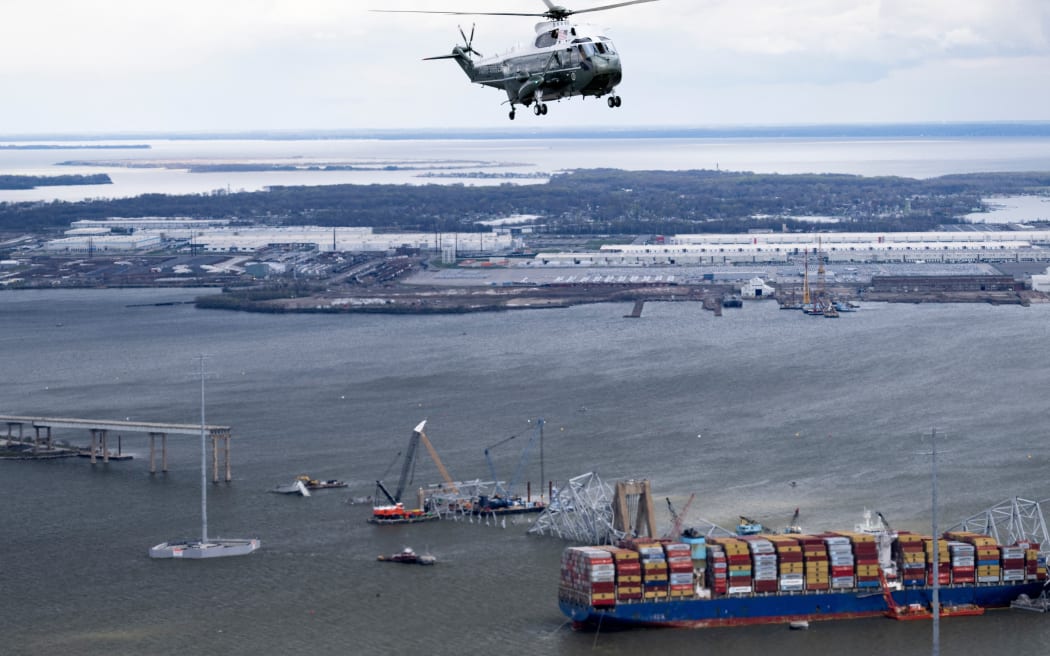 Marine One with US President Joe Biden on board passes over the wreckage of the collapsed Francis Scott Key Bridge and the container ship Dali in Dundalk, Maryland, on 5 April, 2024.