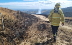 Photos at the fire ground in Kennedys Bush. Firefighter pictured is Ewen Peat - crew leader at High Country Fire Team