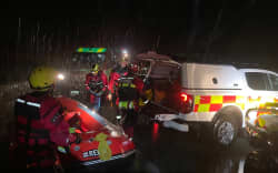 Emergency services free a driver trapped in his car in rising flood waters near Mt Lyford.