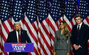 Former US President and Republican presidential candidate Donald Trump speaks at an election night event alongside former US First Lady Melania Trump and their son Barron Trump at the West Palm Beach Convention Center in West Palm Beach, Florida, on November 6, 2024.