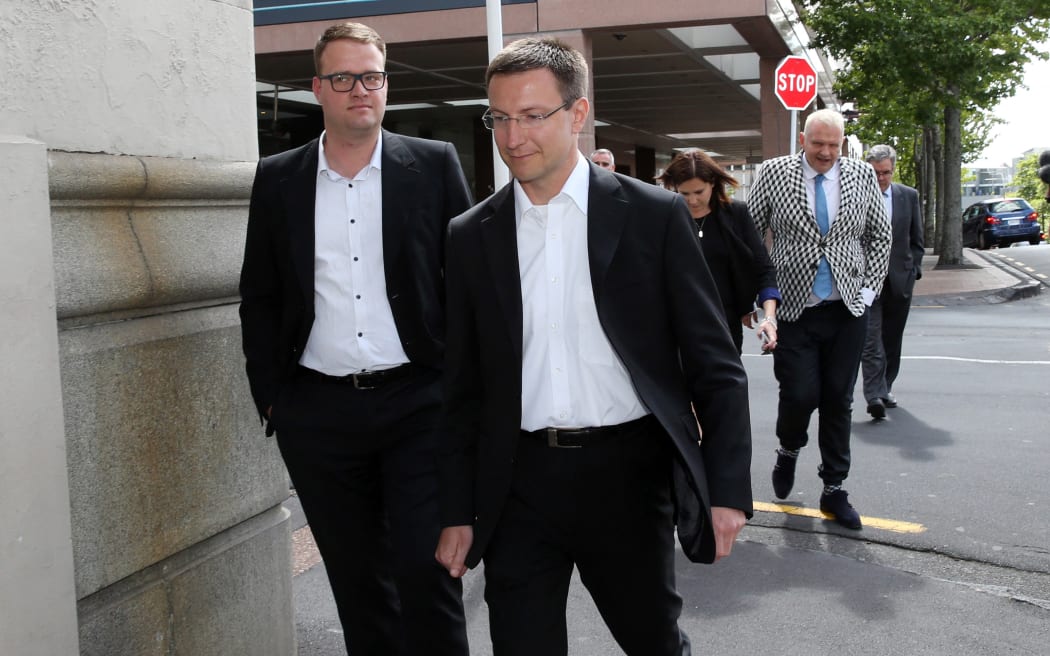 Megaupload executives Mathias Ortmann (2nd L) and Bram van der Kolk (L) leave court after a judge ruled that Internet mogul Kim Dotcom and three other defendants are eligible for extradition to the US, in Auckland on December 23, 2015. A New Zealand judge ruled on December 23 Internet mogul Kim Dotcom can be extradited to the United States where he is wanted on money laundering, racketeering and breach of copyright charges. AFP PHOTO / Michael Bradley (Photo by MICHAEL BRADLEY / AFP)